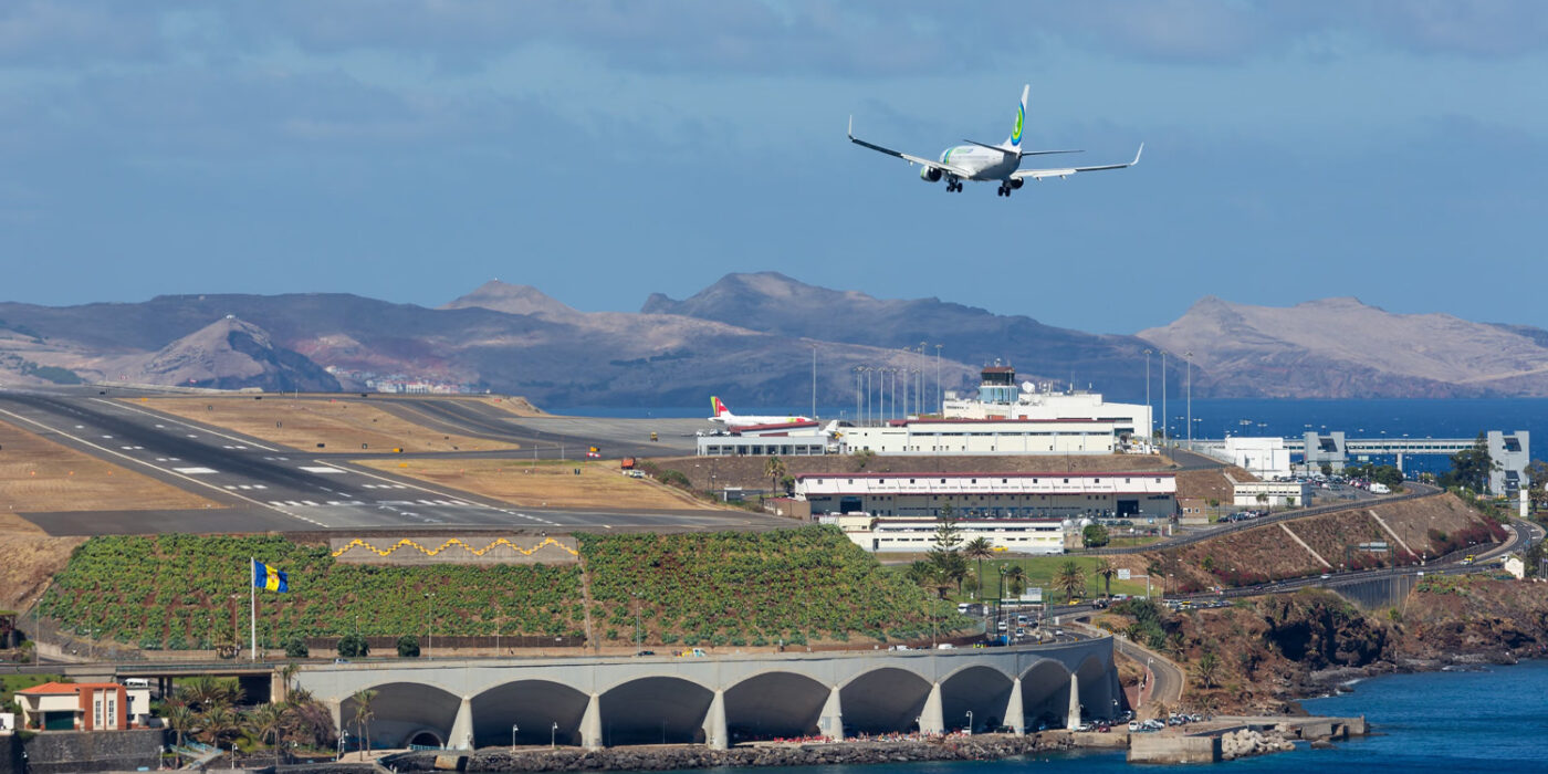 Samolot lądujący na lotnisku na Maderze widziany znad oceanu.